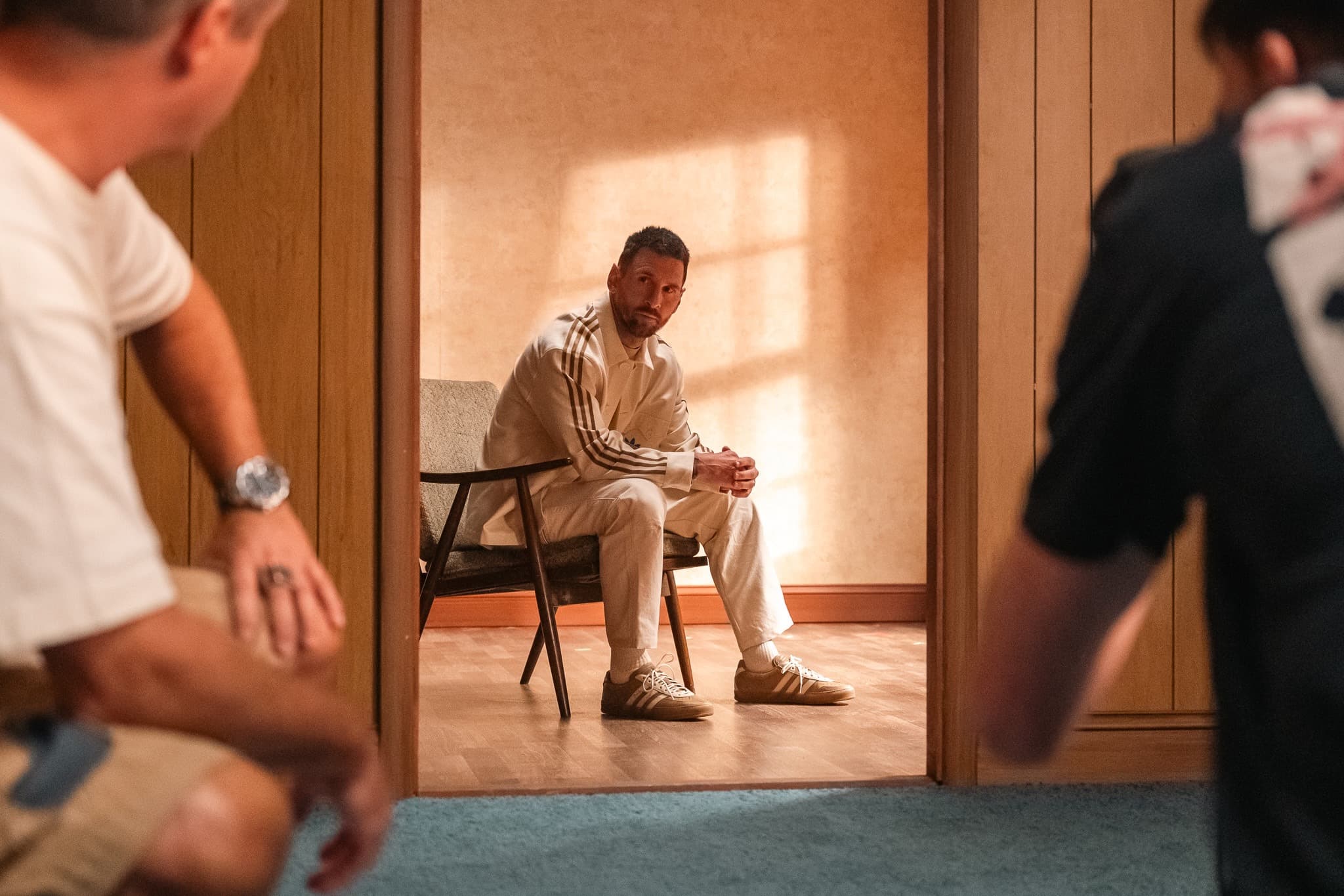 Messi seated in a doorway, framed by the room