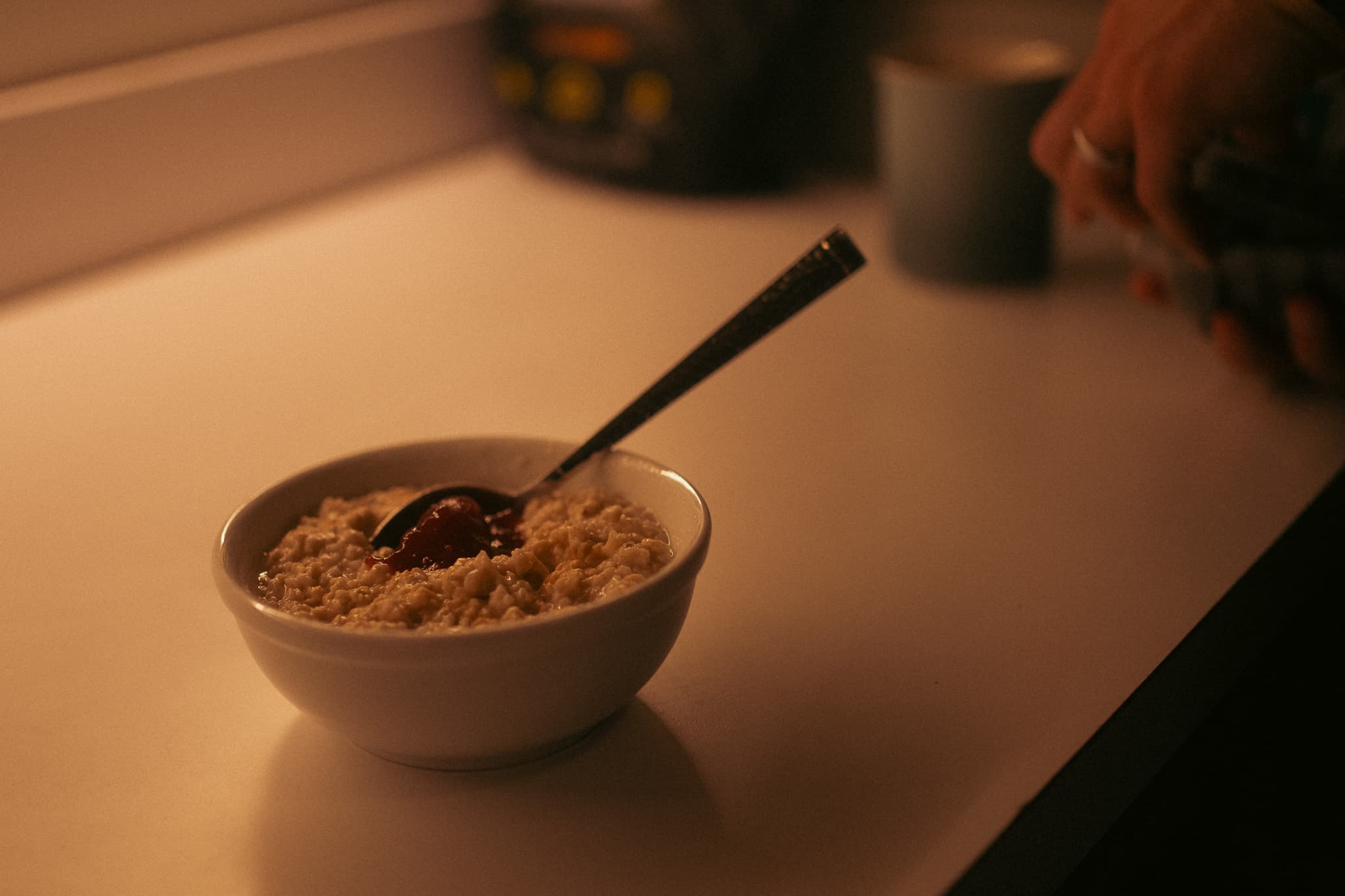 Bowl of oatmeal with spoon on the kitchen counter