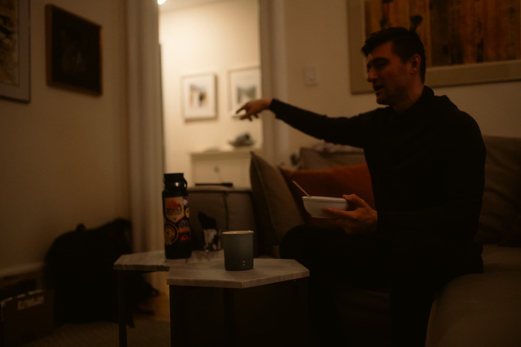 Rider gesturing while eating breakfast in the living room