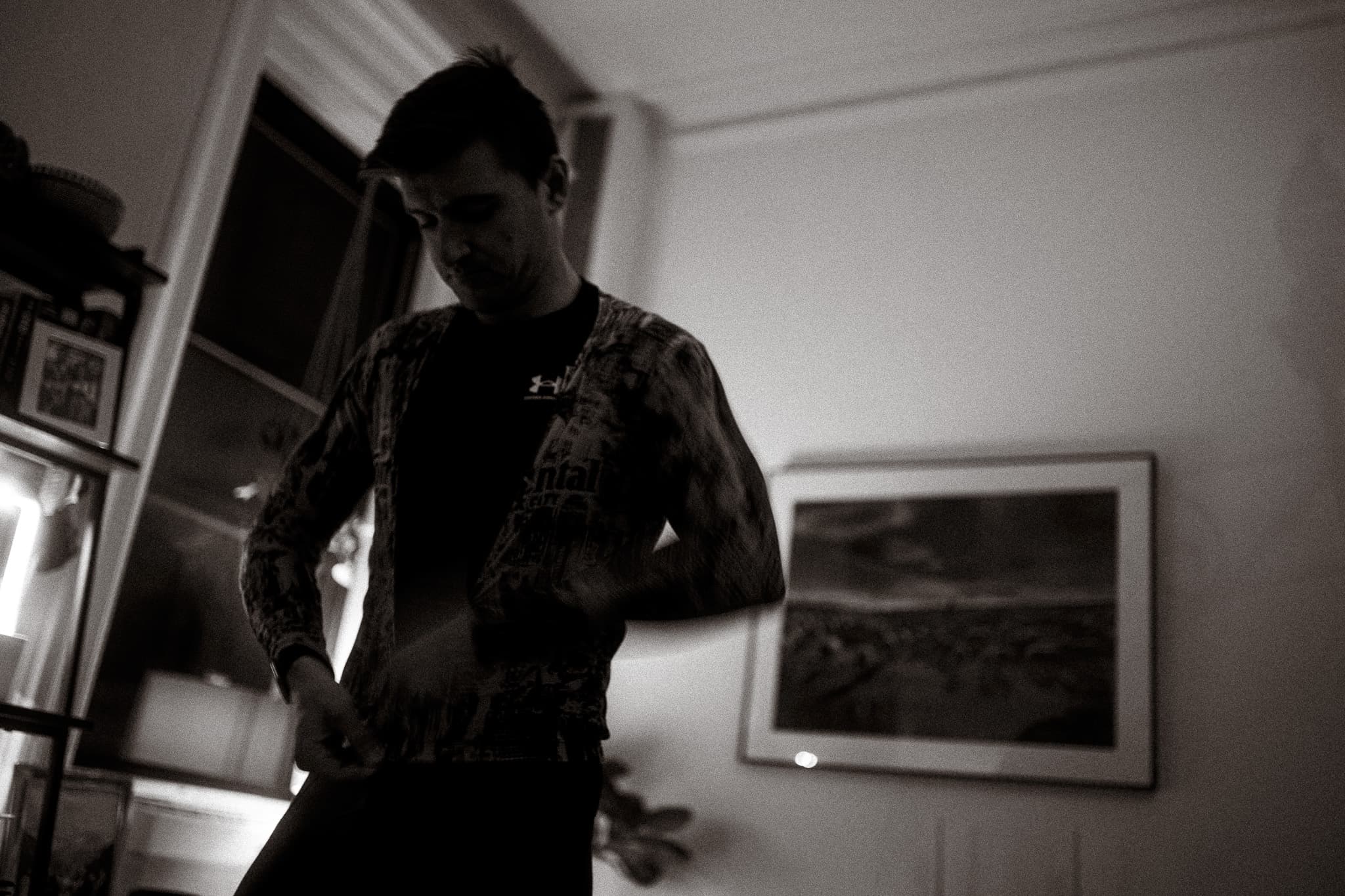 Rider zipping up jersey, low angle, black and white