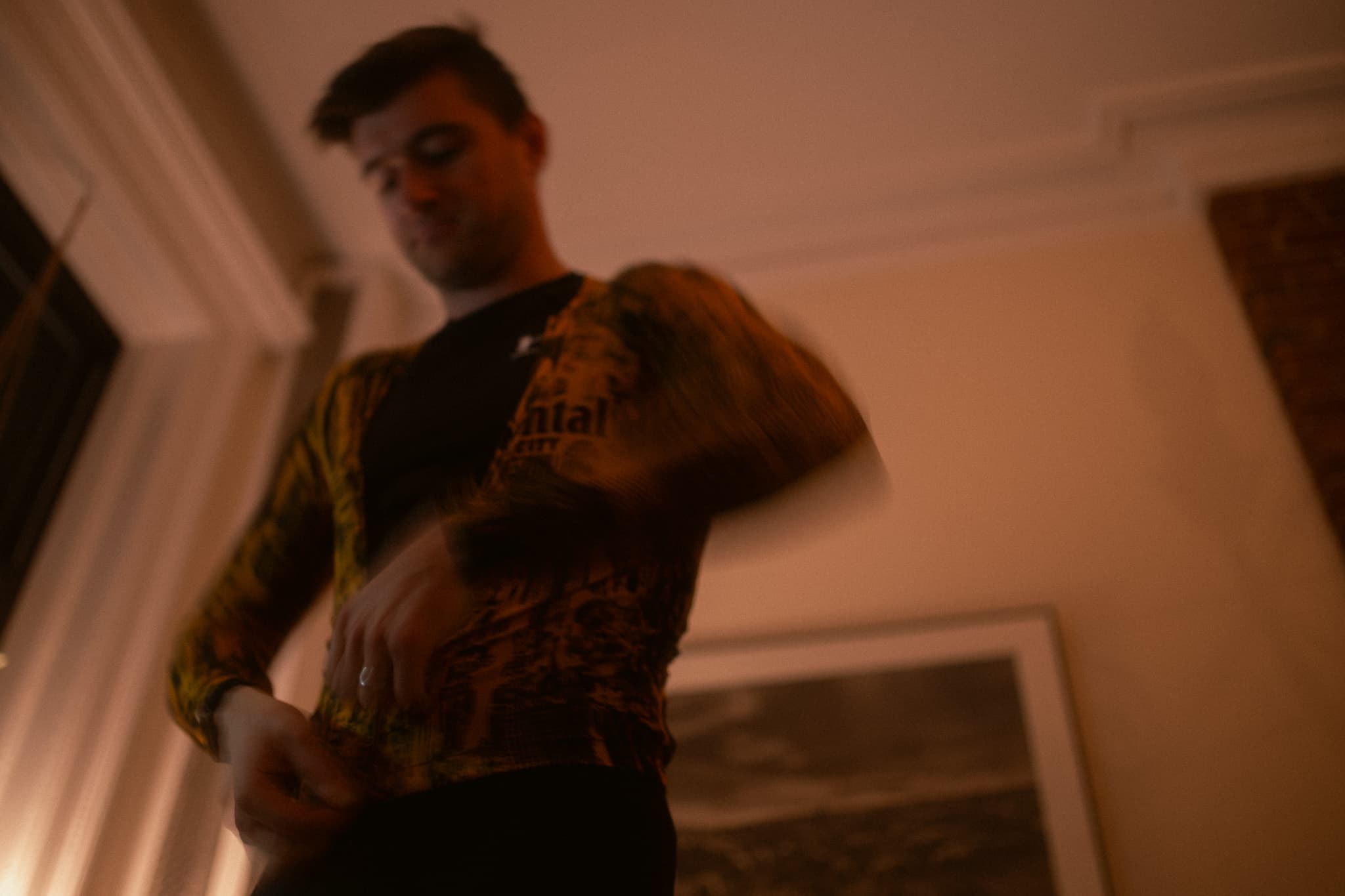 Rider pulling on jersey with motion blur, low angle