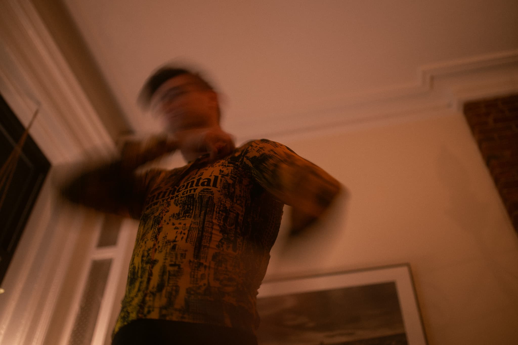 Close-up of rider adjusting jersey, heavy motion blur