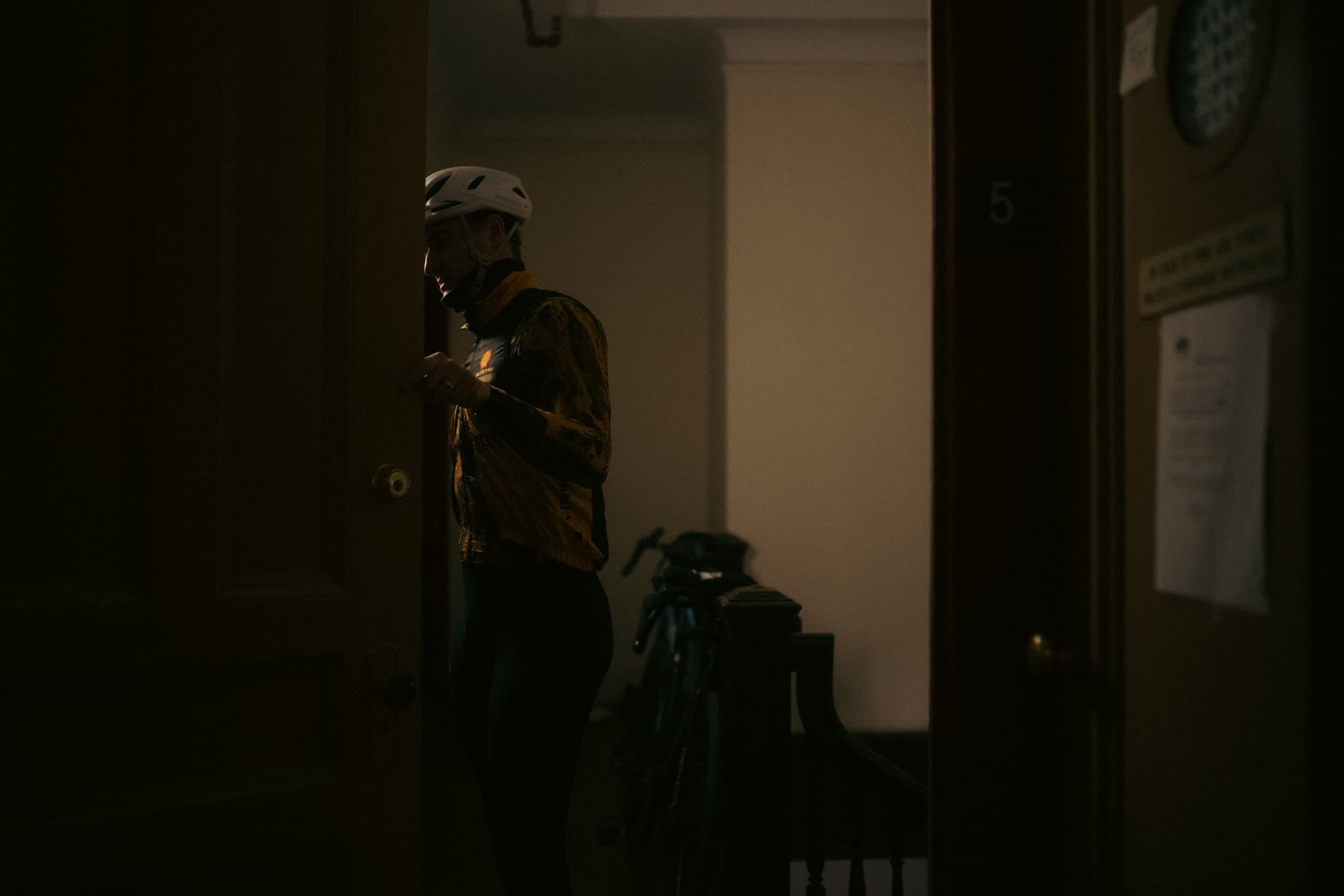 Rider in full kit at the apartment door, ready to leave